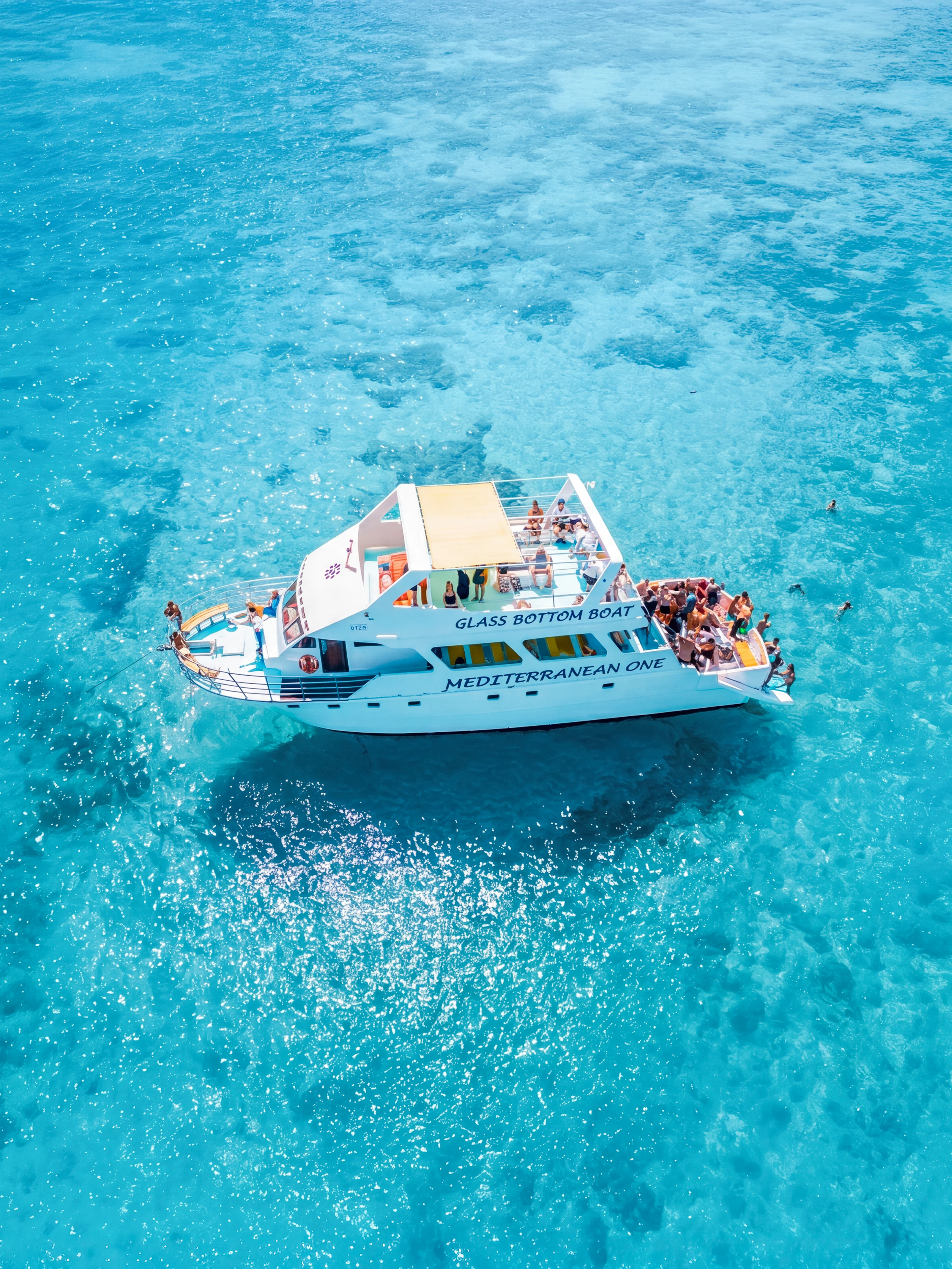 Glass-bottom boat Mediterranean One cruising in clear blue waters near Latchi.