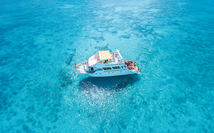 Glass-bottom boat Mediterranean One cruising in clear blue waters near Latchi.