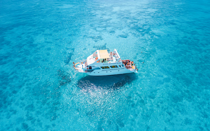 Glass-bottom boat Mediterranean One cruising in clear blue waters near Latchi.