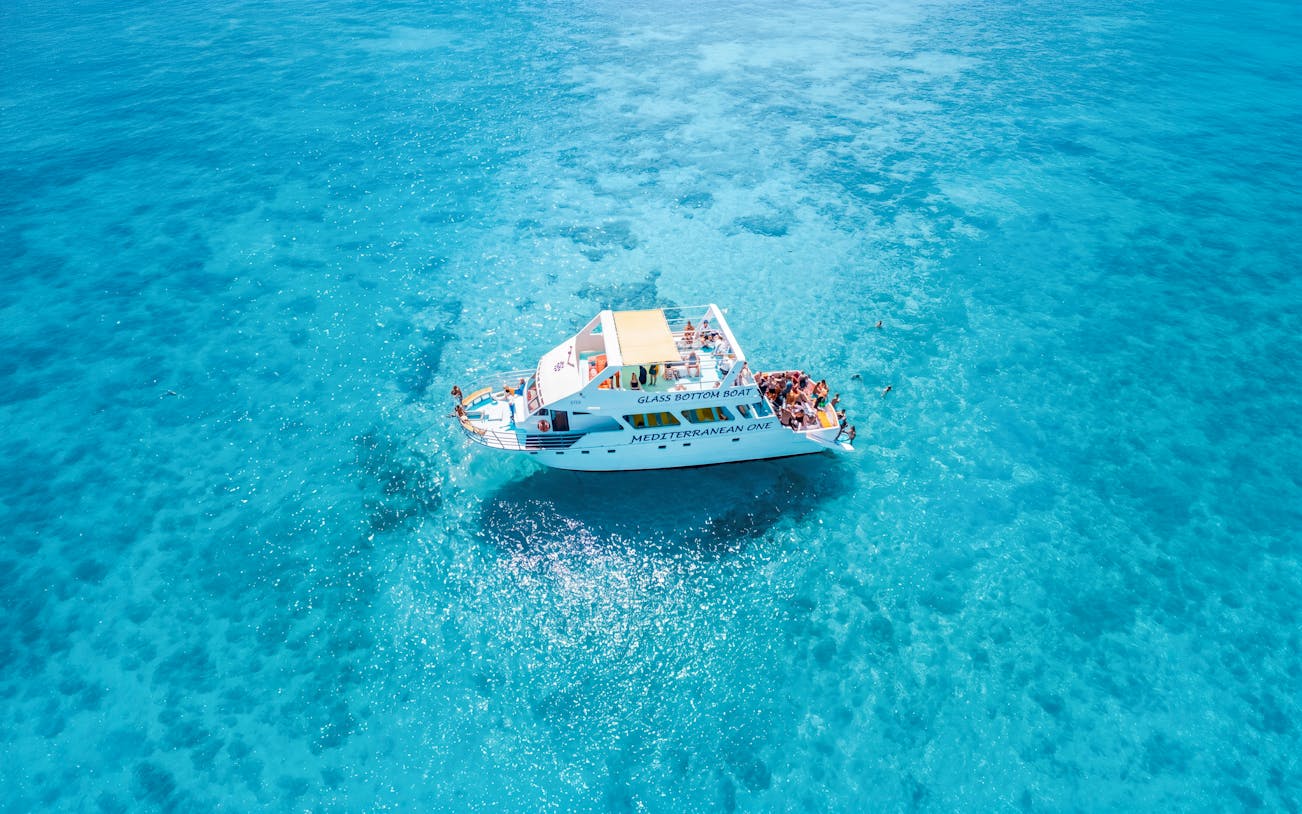 Glass-bottom boat Mediterranean One cruising in clear blue waters near Latchi.