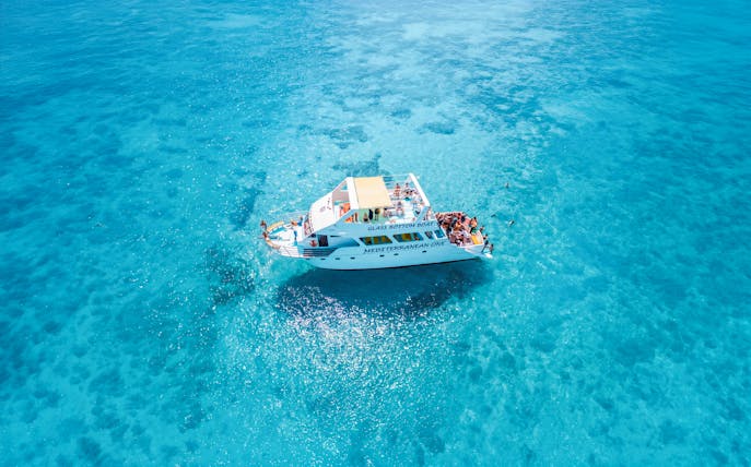 Glass-bottom boat Mediterranean One cruising in clear blue waters near Latchi.