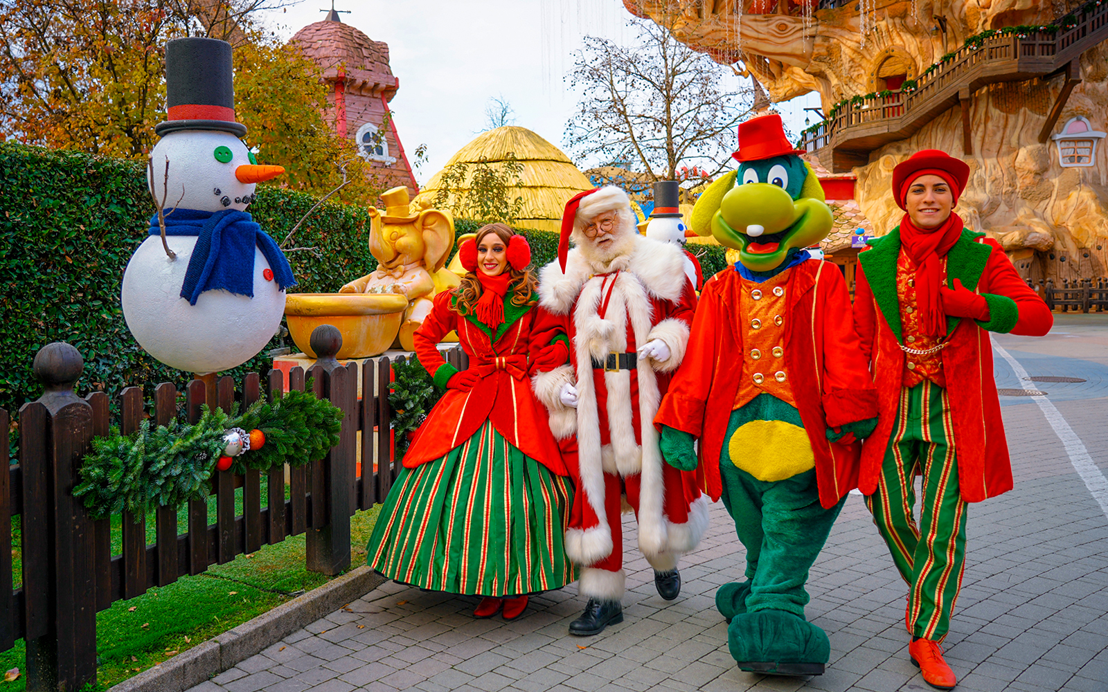 Santa Claus and friends walking at Gardaland Park with festive decorations.