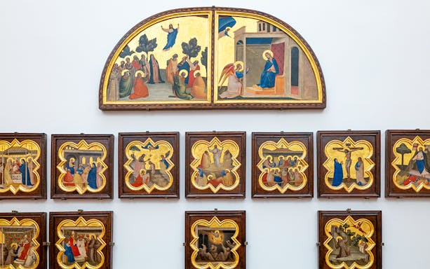 Accademia Gallery art display in Florence, Italy, featuring religious paintings with timed entry tickets.