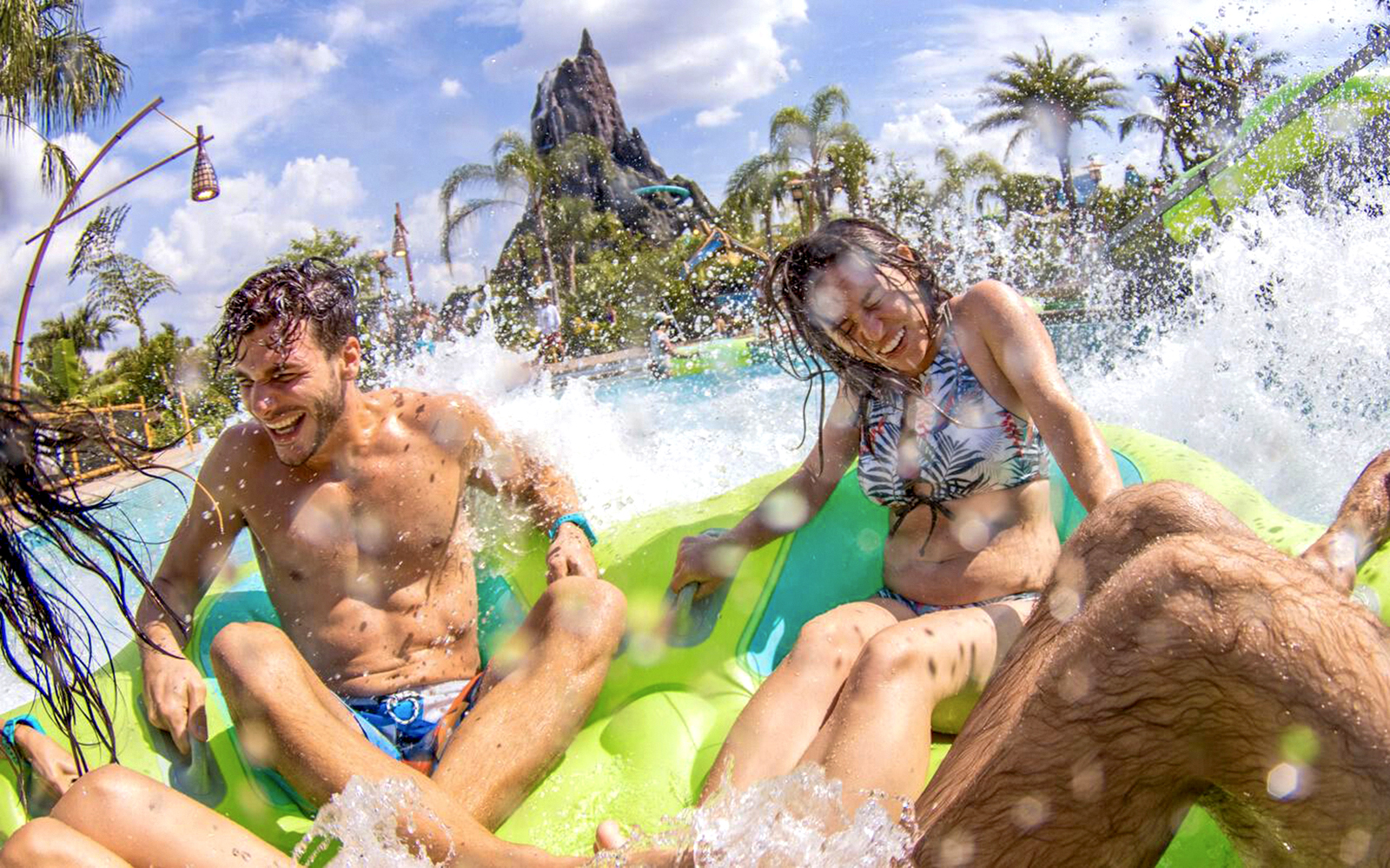 Guests splashing on a water ride at Volcano Bay, Universal Studios Orlando.
