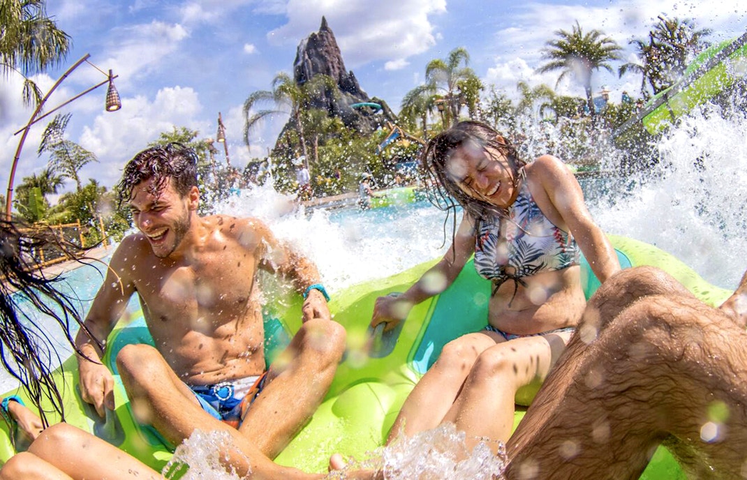 Guests splashing on a water ride at Volcano Bay, Universal Studios Orlando.