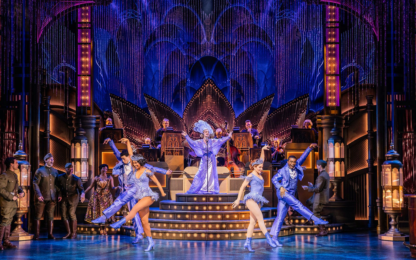Stage performance of The Great Gatsby with dancers and musicians in vibrant costumes.