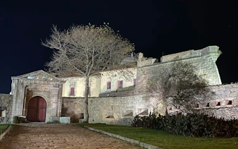 Fortress of São João Baptista at night in Porto, Portugal, part of a self-guided city exploration game.