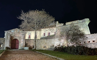 Fortress of São João Baptista at night in Porto, Portugal, part of a self-guided city exploration game.