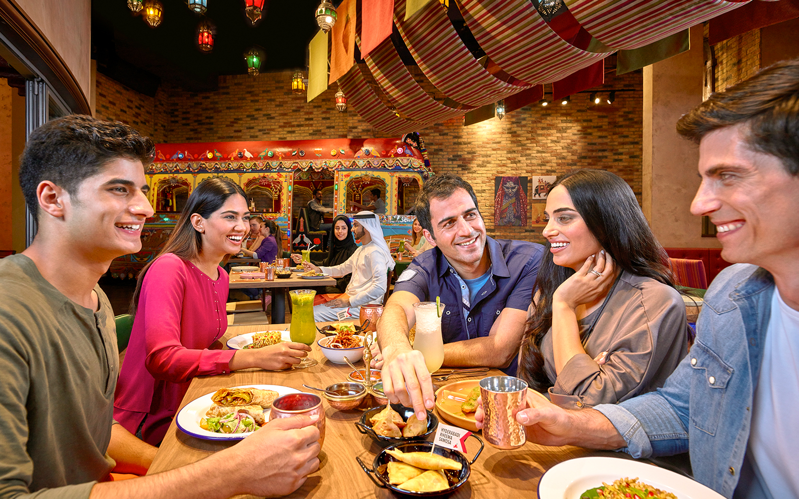 Dining experience at a vibrant restaurant in Dubai, part of Ski Dubai and IMG Worlds of Adventure combo offer.