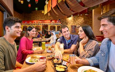 Dining experience at a vibrant restaurant in Dubai, part of Ski Dubai and IMG Worlds of Adventure combo offer.