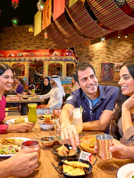 Dining experience at a vibrant restaurant in Dubai, part of Ski Dubai and IMG Worlds of Adventure combo offer.