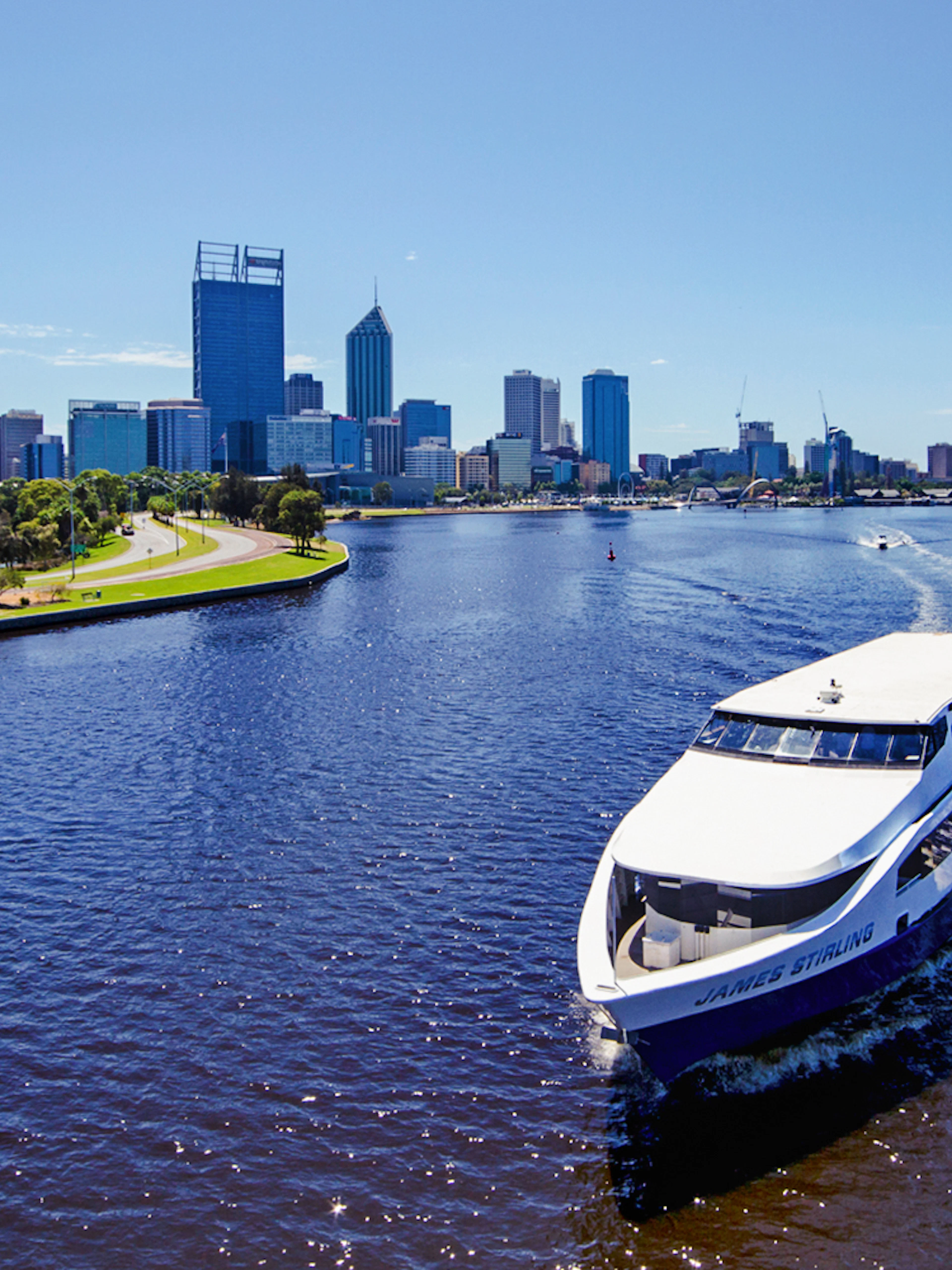 Cruise boat on Swan River with Perth skyline in the background.