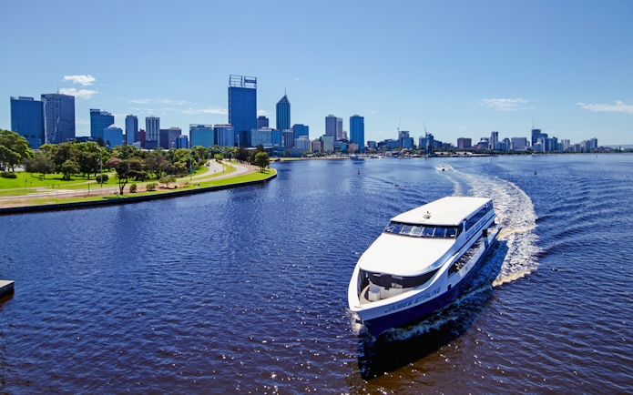 Cruise boat on Swan River with Perth skyline in the background.