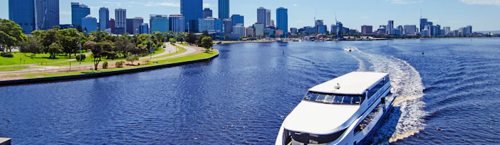 Cruise boat on Swan River with Perth skyline in the background.