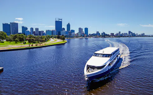 Cruise boat on Swan River with Perth skyline in the background.