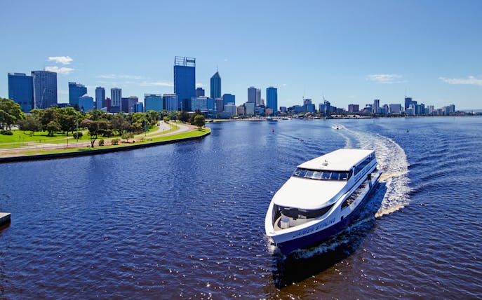 Cruise boat on Swan River with Perth skyline in the background.
