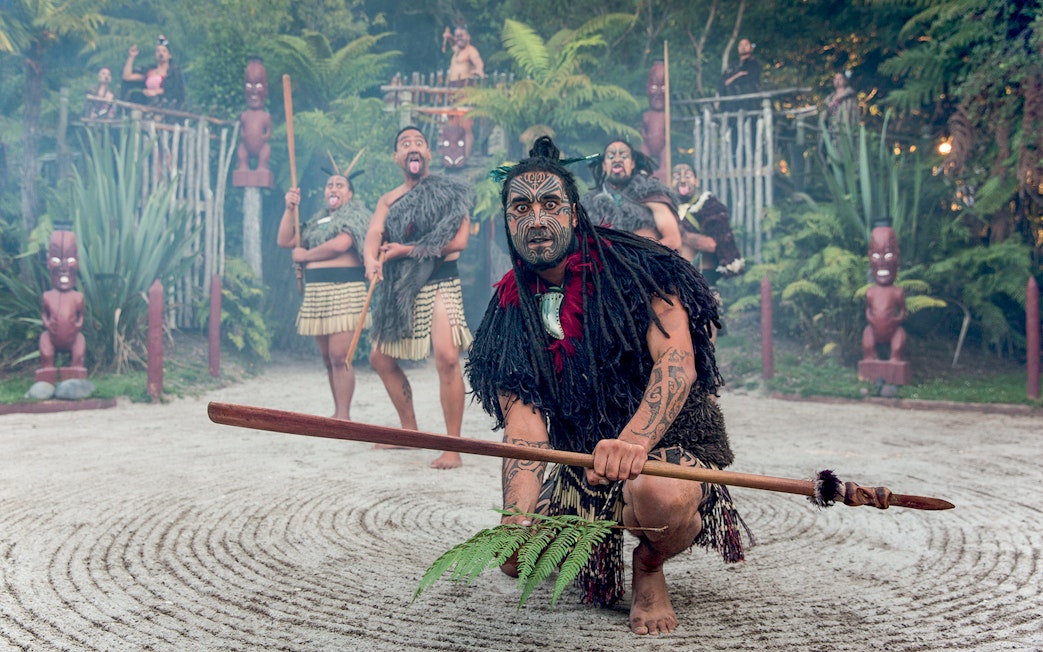 Maori performers in traditional attire during cultural show, Rotorua, New Zealand.