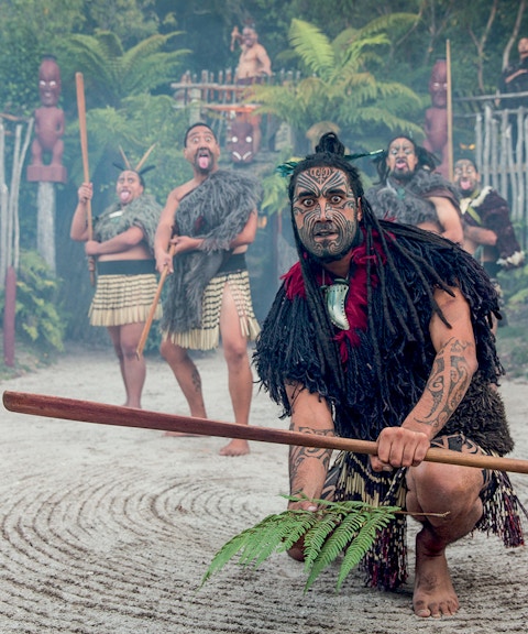 Maori performers in traditional attire during cultural show, Rotorua, New Zealand.