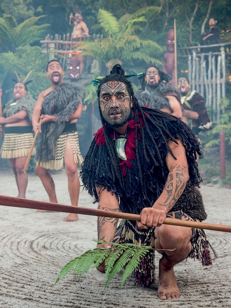 Maori performers in traditional attire during cultural show, Rotorua, New Zealand.