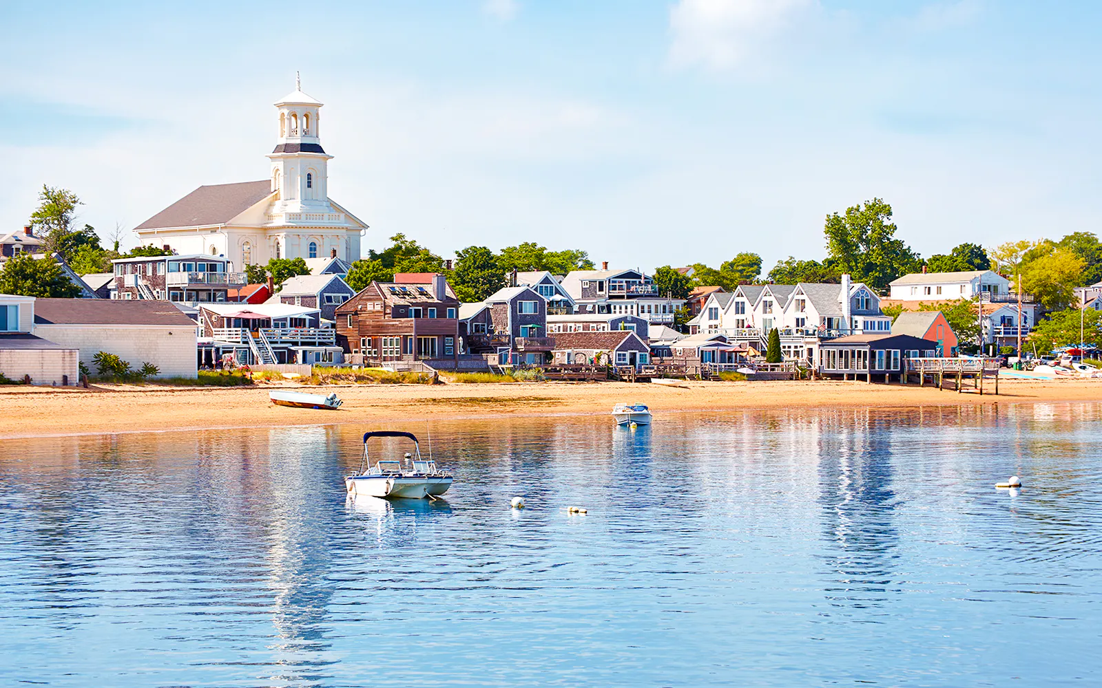 Provincetown beach with boats and historic buildings, Cape Cod.