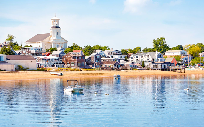 Provincetown beach with boats and historic buildings, Cape Cod.