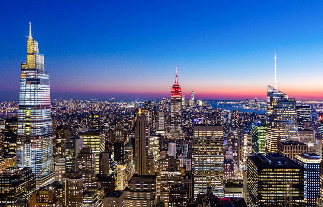 SUMMIT One Vanderbilt night view of New York City skyline with illuminated skyscrapers.
