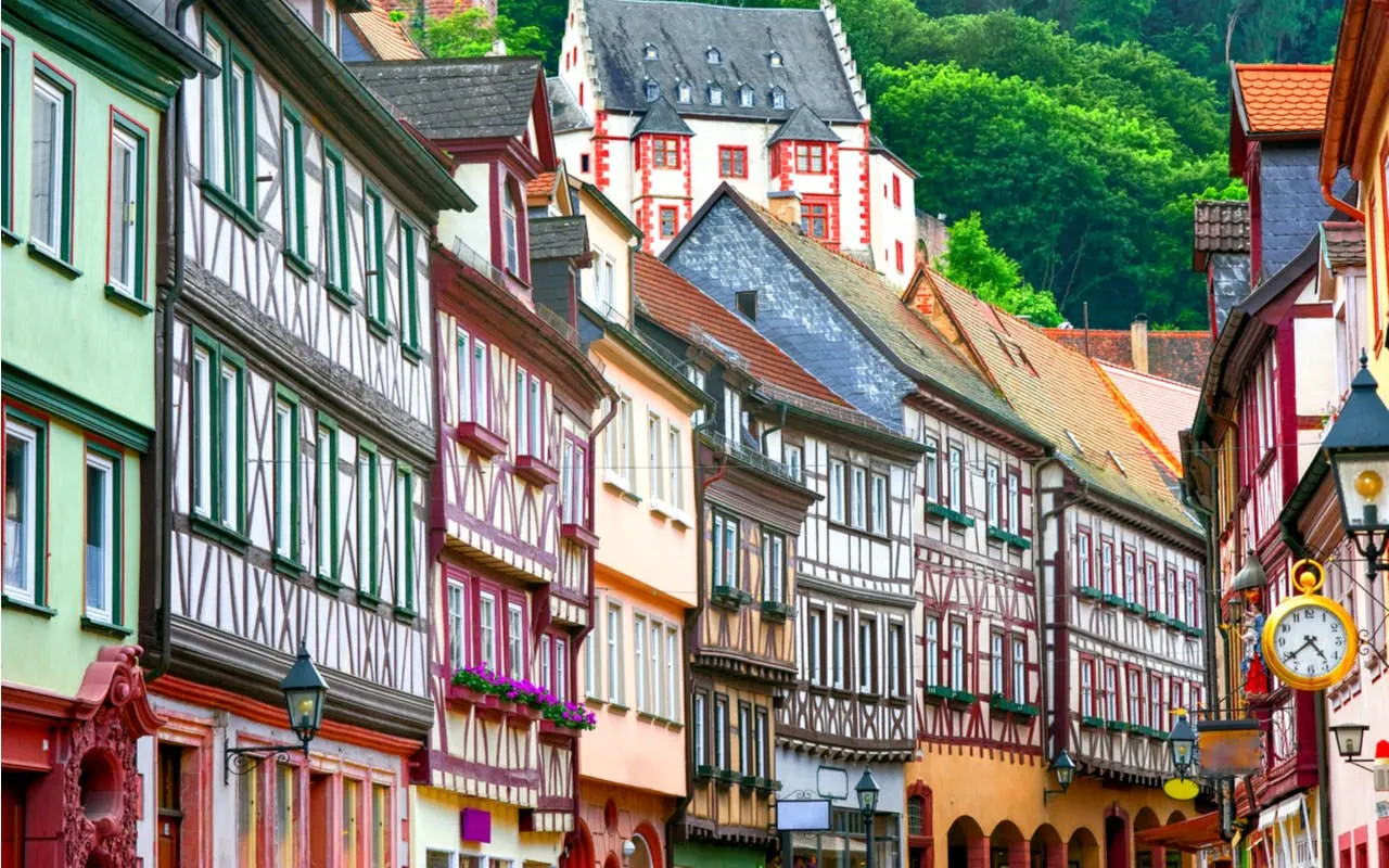 Half-timbered houses in Old Town Frankfurt, Germany, with colorful facades and a historic clock.