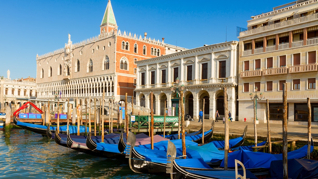find gondola stations along the waterfront near the Doge's Palace.