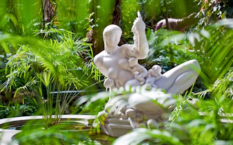 Marble sculpture "The Water Mother" surrounded by greenery at Ny Carlsberg Glyptotek, Copenhagen.