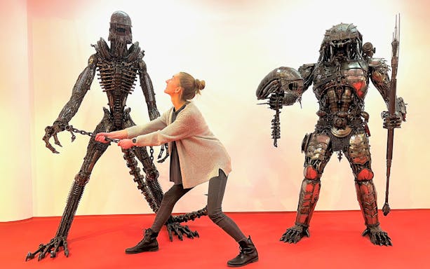 Person interacting with steel sculptures at Gallery of Steel Figures, Prague.