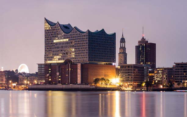 Elbphilharmonie concert hall and St. Pauli district skyline at dusk, Hamburg.