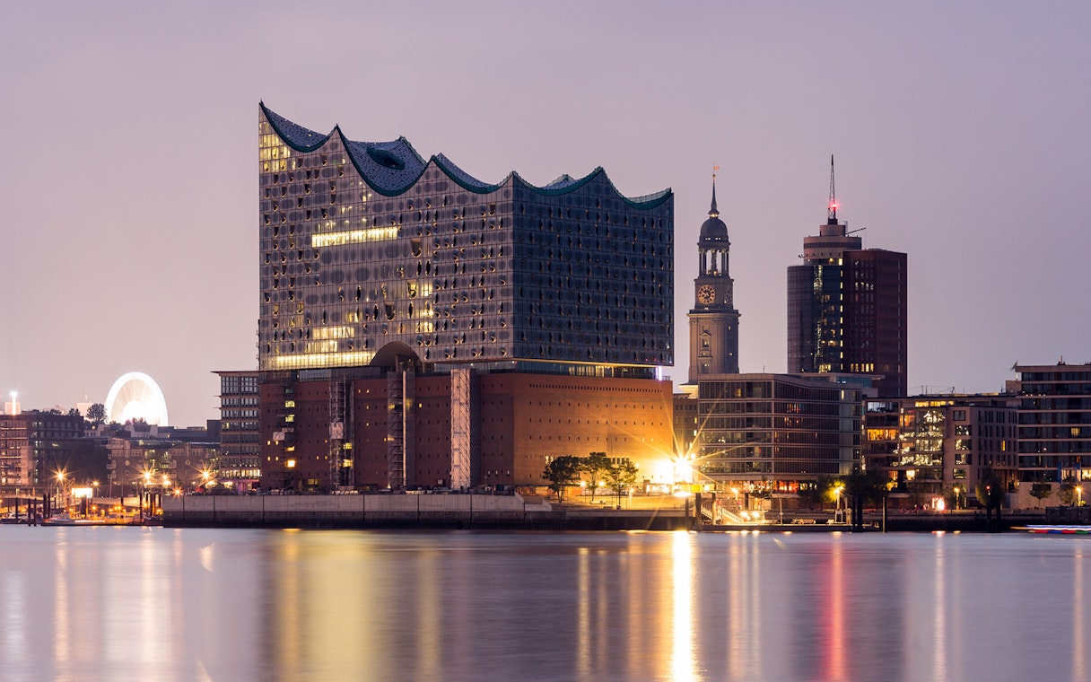 Elbphilharmonie at dusk in Hamburg, Germany, viewed from the water.