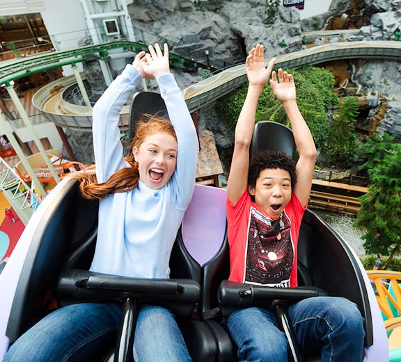 Guests enjoying a roller coaster ride at Nickelodeon Universe, Mall of America.