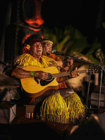 Performer playing guitar at Chief's Luau, Oahu, Hawaii.