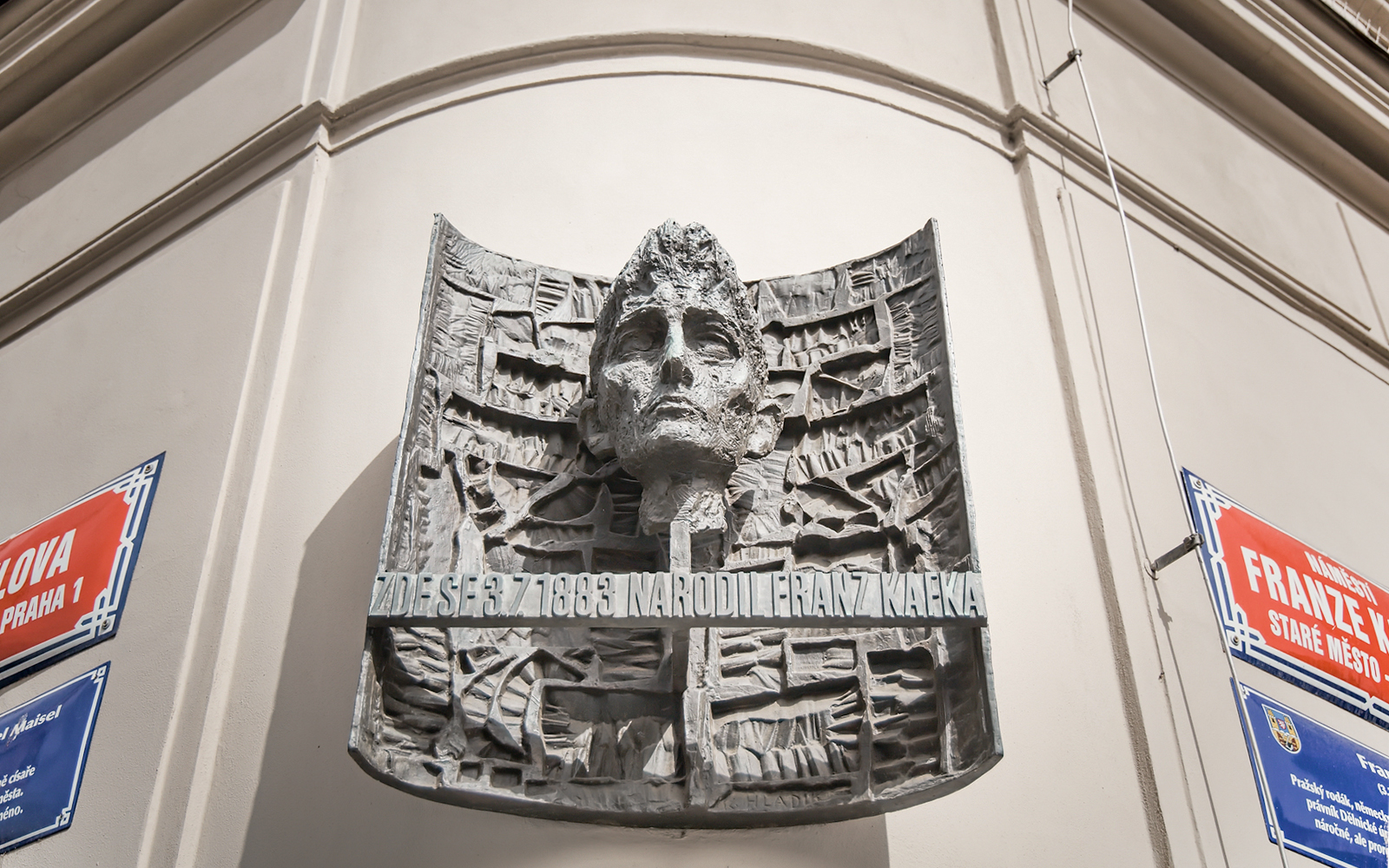 Franz Kafka sculpture on a building in Prague's Old Town.