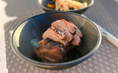 Slices of grilled meat served in a bowl on Auckland Harbour dinner cruise.