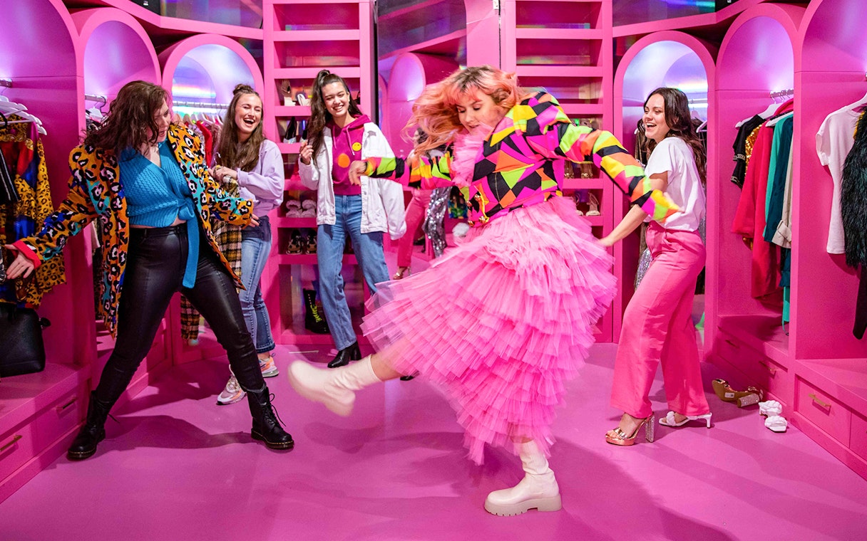 Visitors enjoying colorful room at Upside Down Amsterdam.