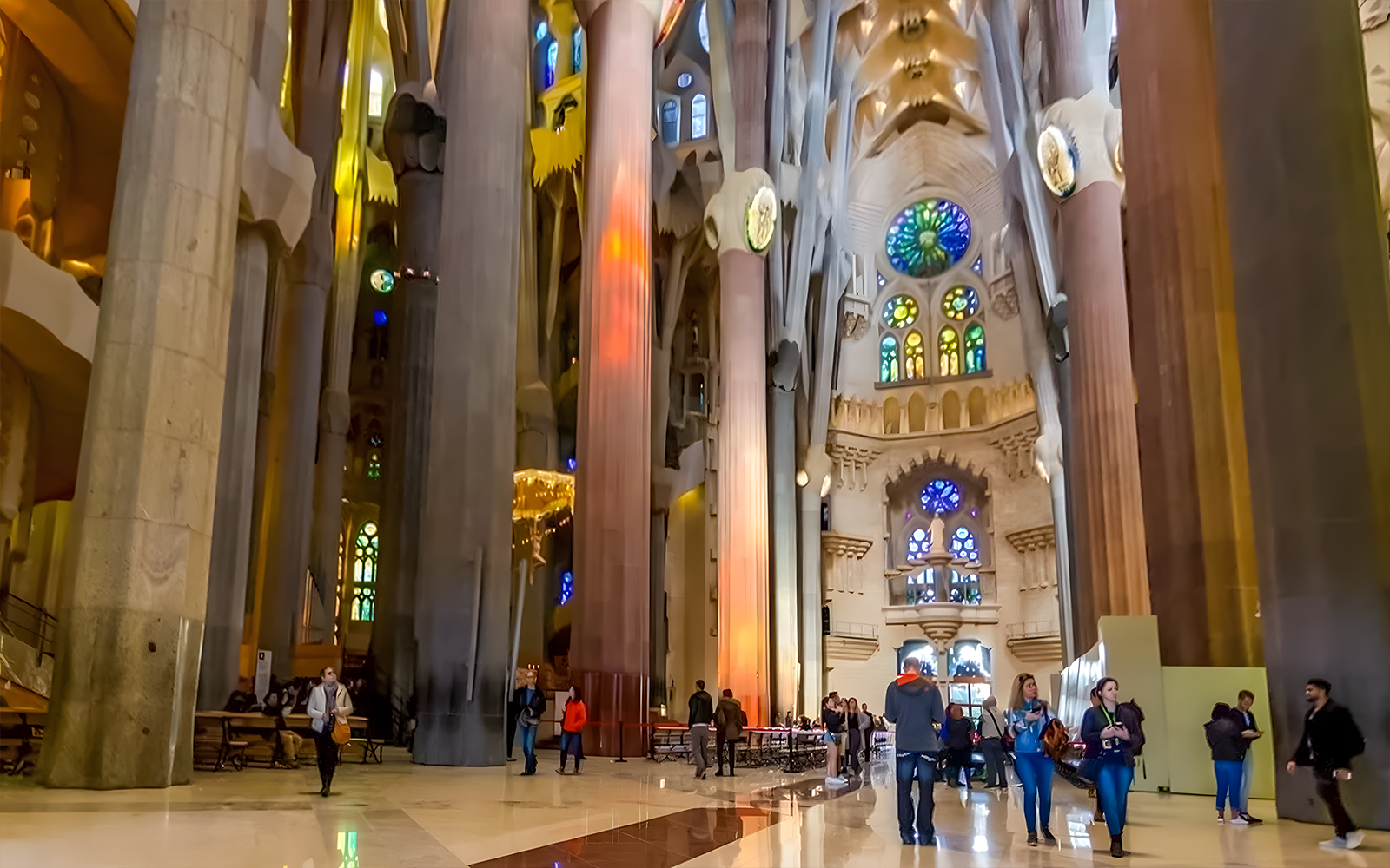 Sagrada Familia interior with intricate stained glass windows and towering columns in Barcelona, Spain.