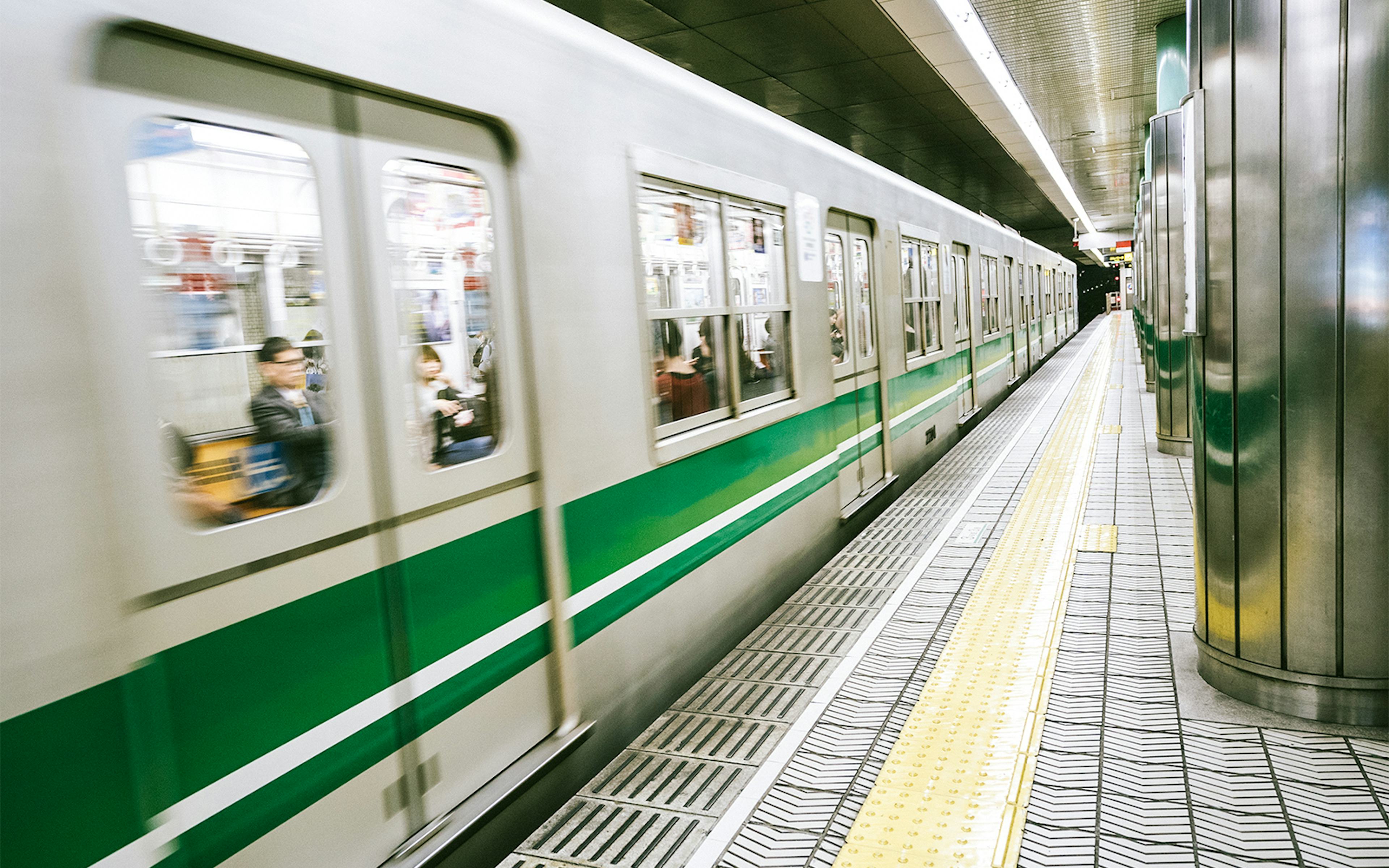 Subway train arriving at a station in Osaka, Japan, near Osaka Castle.