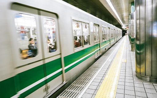 Subway train arriving at a station in Osaka, Japan, near Osaka Castle.