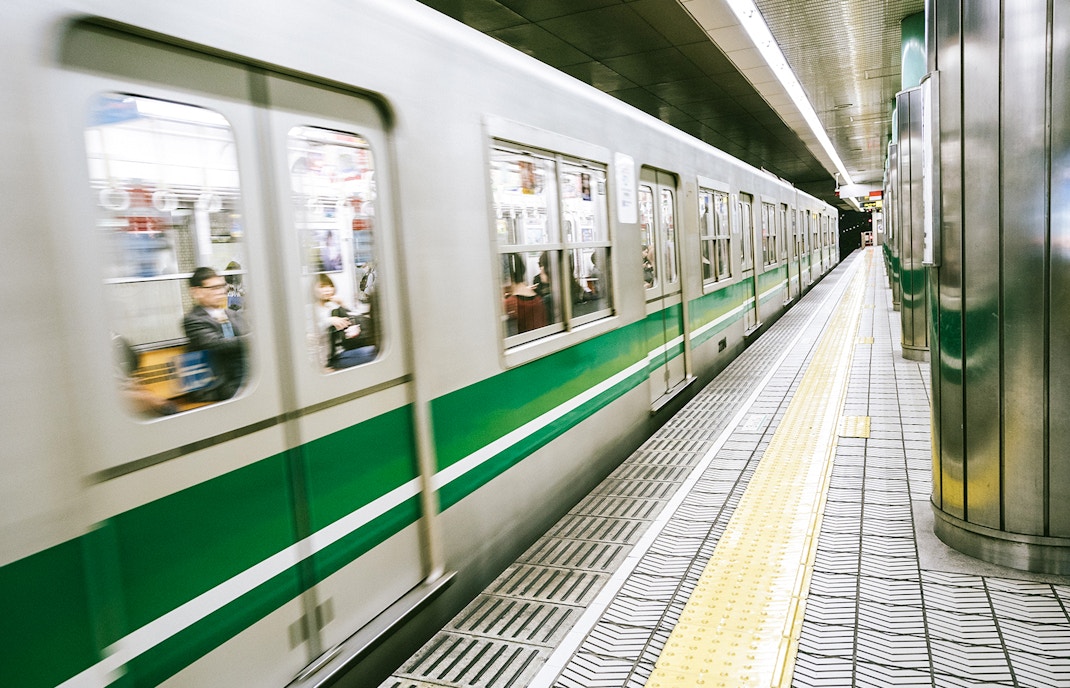 Subway train arriving at a station in Osaka, Japan, near Osaka Castle.