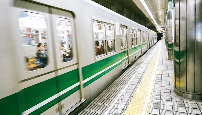 Subway train arriving at a station in Osaka, Japan, near Osaka Castle.