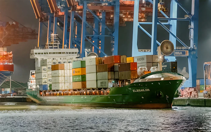 Cargo ship docked at night in Grand Harbor during evening lights cruise.
