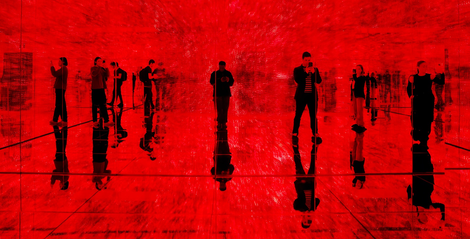 Visitors exploring a red mirrored room at Mercer Labs: Museum Of Art & Technology exhibit.