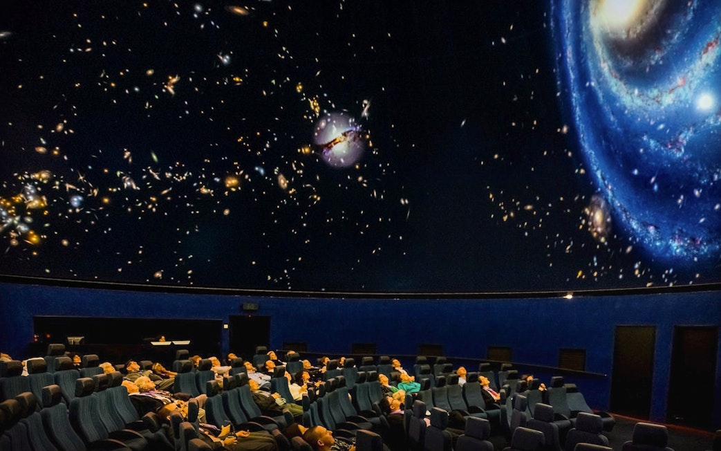 Visitors watching an interactive galaxy show at Scienceworks planetarium.