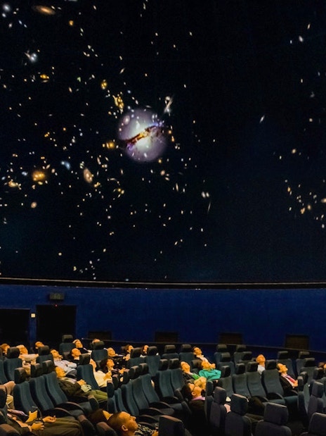 Visitors watching an interactive galaxy show at Scienceworks planetarium.