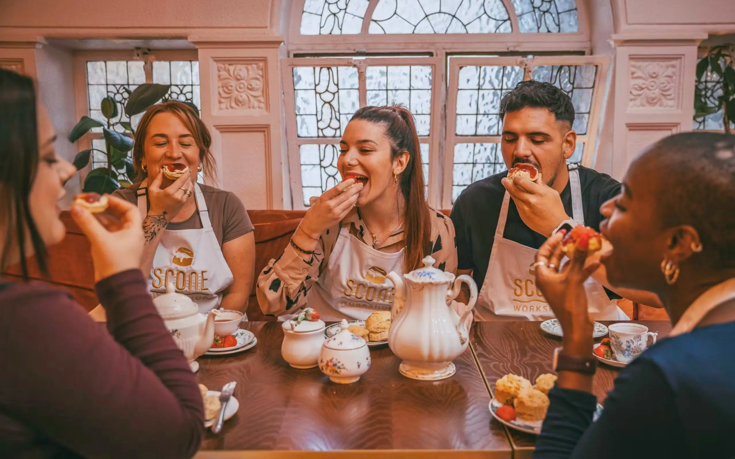 Participants enjoying scones and tea at a workshop in London.