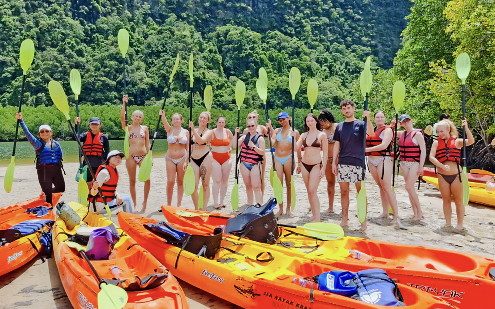 Tourists preparing to kayak at Ao Thalane, surrounded by mangrove forests.