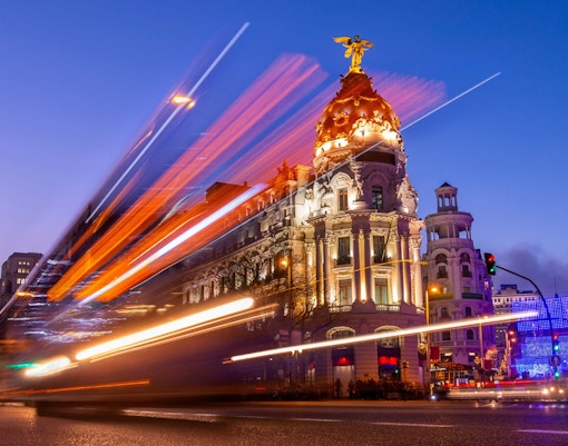 Metropolis Building illuminated at night on Gran Vía, Madrid, Spain.