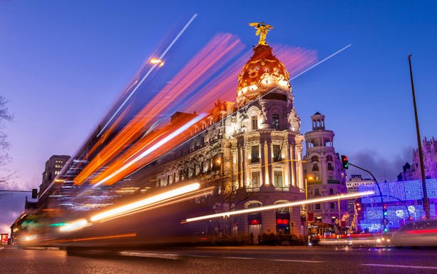 Metropolis Building illuminated at night on Gran Vía, Madrid, Spain.